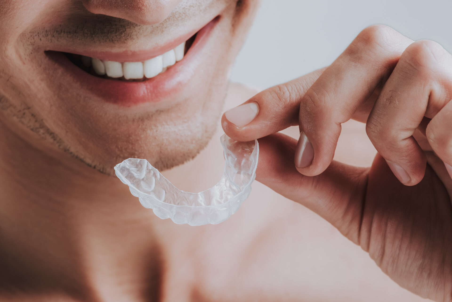 Man holding transparent mouth guard | Crane & Seager Orthodontics in Fort Collins and Loveland, CO